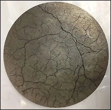 A ceramic target cracked because of thermal shock.